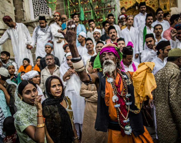 A Sufi Muslim devotee gestures to other pilgrims to enter the 'durgah' or shrine, where Muhammad Moin-ud-din Chisti is buried, during the annual 'Urs' procession.