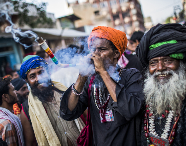 Sufi Muslim devotees smoke marijuana from a pipe during the annual 'Urs' procession.
