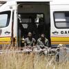 
                                            Suspected illegal miners await treatment after emerging from an abandoned gold shaft in Benoni, east of Johannesburg, February 17, 2014. REUTERS/Mike Hutchings