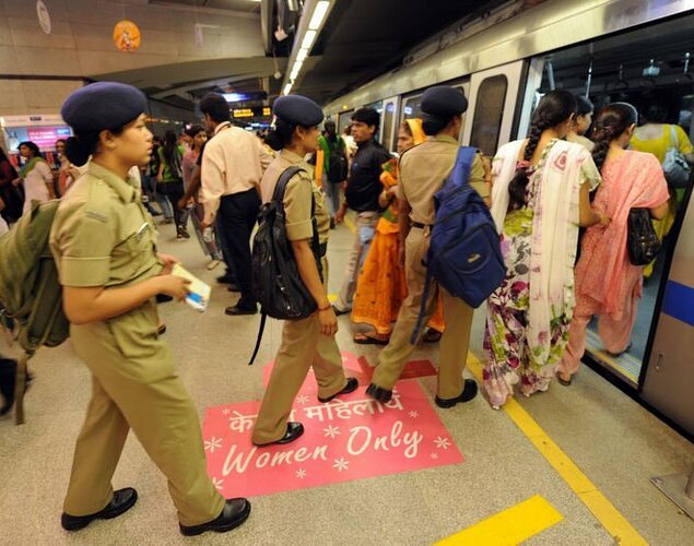 Female commuters are pictured on October 2, 2010 boarding a women-only compartment at a New Delhi train station