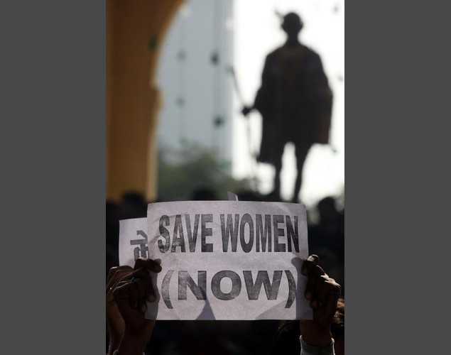Indian protestors rally in front of a statue of Mahatma Gandhi in Lucknow, after the death of a gangrape victim in the capital New Delhi, December 29, 2012