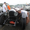A man looks at a Bentley 1928 classic car before the 